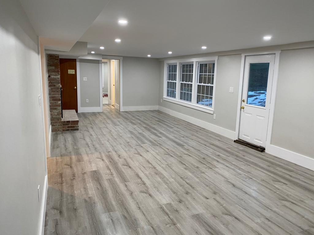 Living room featuring vinyl plank flooring types expertly installed by Goveias.