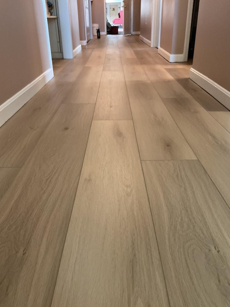 Vinyl plank flooring types lining the hallway, installed by Goveias.