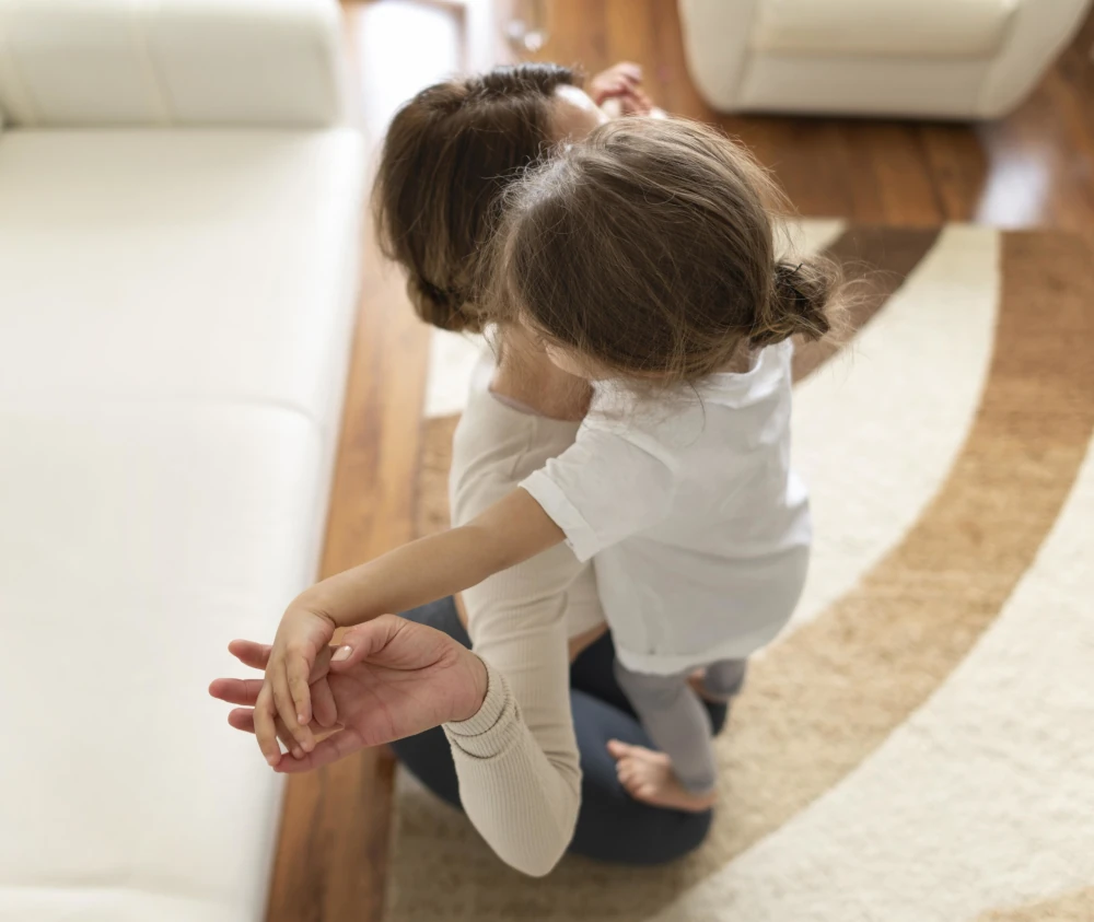 Woman and kid working out on the floor, representing the importance of choosing quality materials for your home expansion.