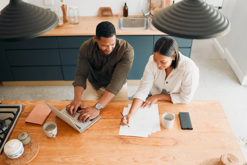 A couple calculating their budget while planning with home renovation tips.