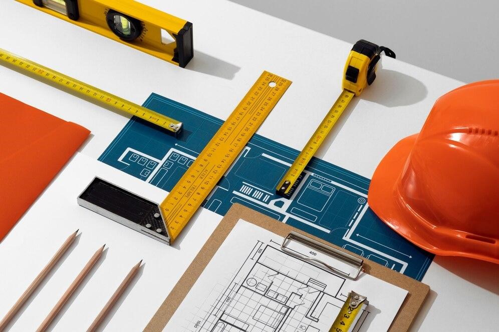  Construction tools on a table, representing the importance of choosing top construction companies services.
