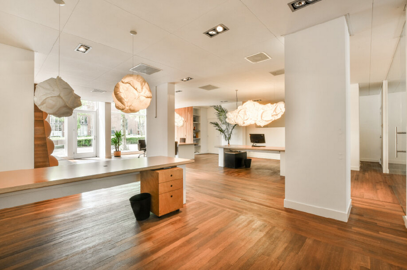 A house interior with white walls and hardwood flooring installed.