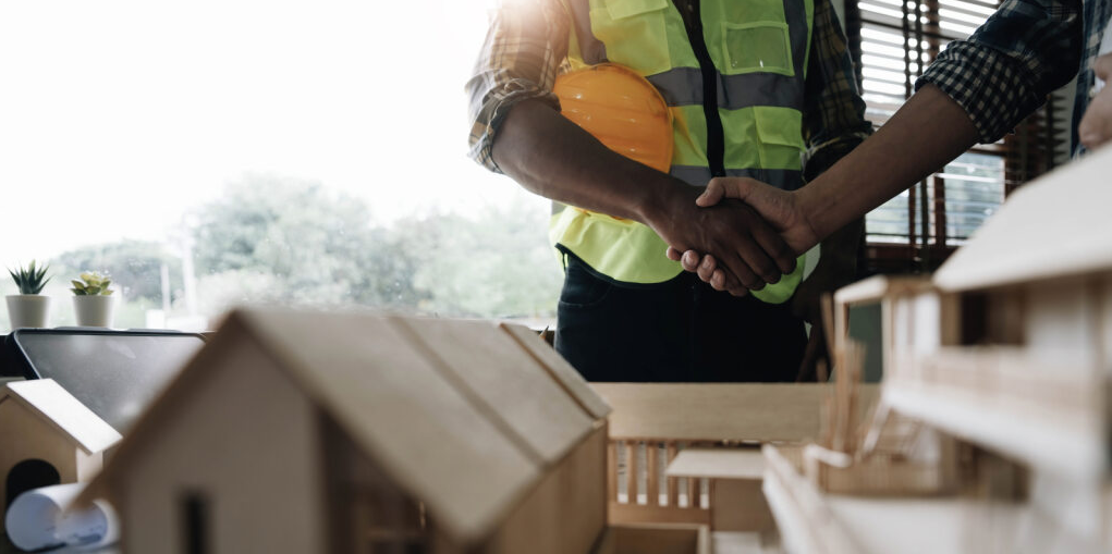 A handshake between the construction contractor and the client to deliver the project on time, because the professionals knew how to avoid delays in commercial construction.