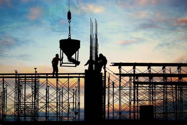 Image of male silhouettes in a construction site, reinforcing the importance of cost-saving in commercial construction